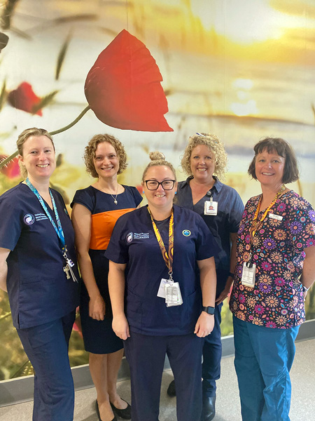 five midwives stood in front of a decorative wall in a NHW birth-suite 
