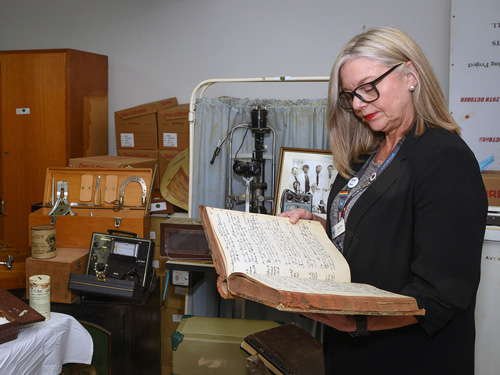 Libby Fifis looking through 150 years of NHW memorabilia