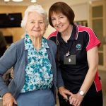 Female staff member with resident smiling