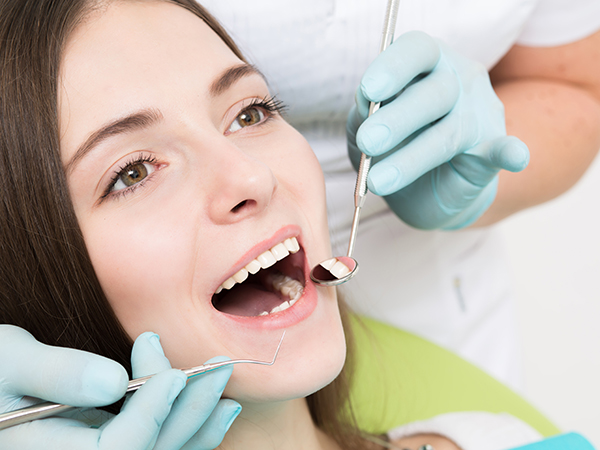 close up of young lady in a dentist chair having her teeth checked