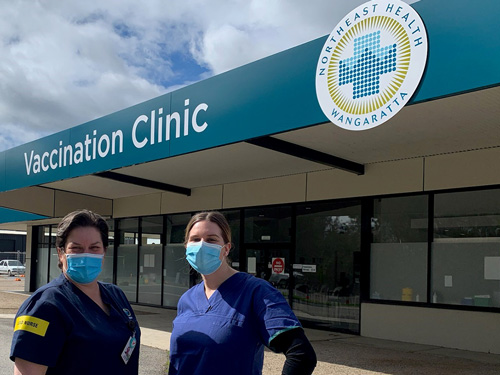 nurses stood outside vaccination clinic
