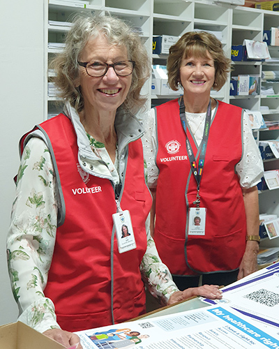 Two ladies in NHW volunteer uniforms.